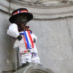 Manneken-Pis statue in Brussels dressed in a costume, symbolizing Xiaomi's official launch in Belgium