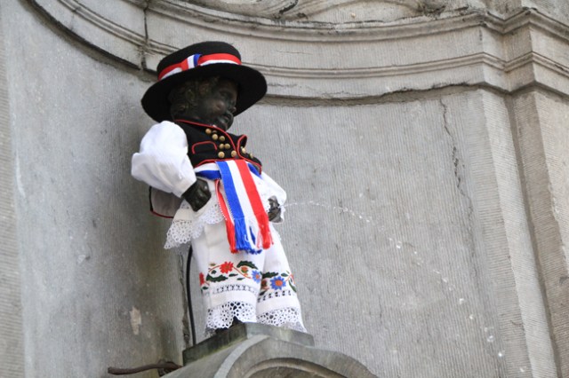 Manneken-Pis statue in Brussels dressed in a costume, symbolizing Xiaomi's official launch in Belgium