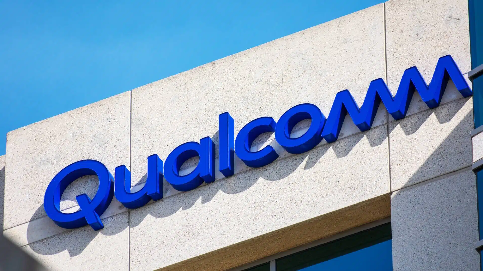 Blue Qualcomm logo on a building facade