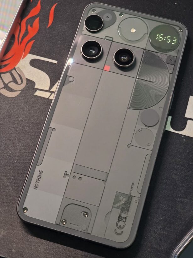 Nothing Phone (3) back panel showing transparent design with visible internals and illuminated Glyph Matrix displaying 16:53