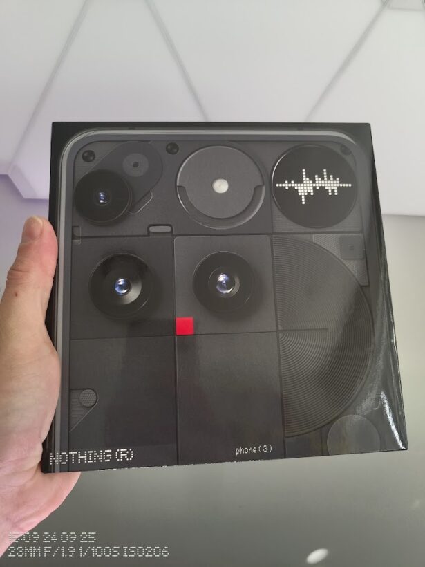 Nothing Phone (3) retail box held in hand, showing the back with camera modules and Glyph Matrix display