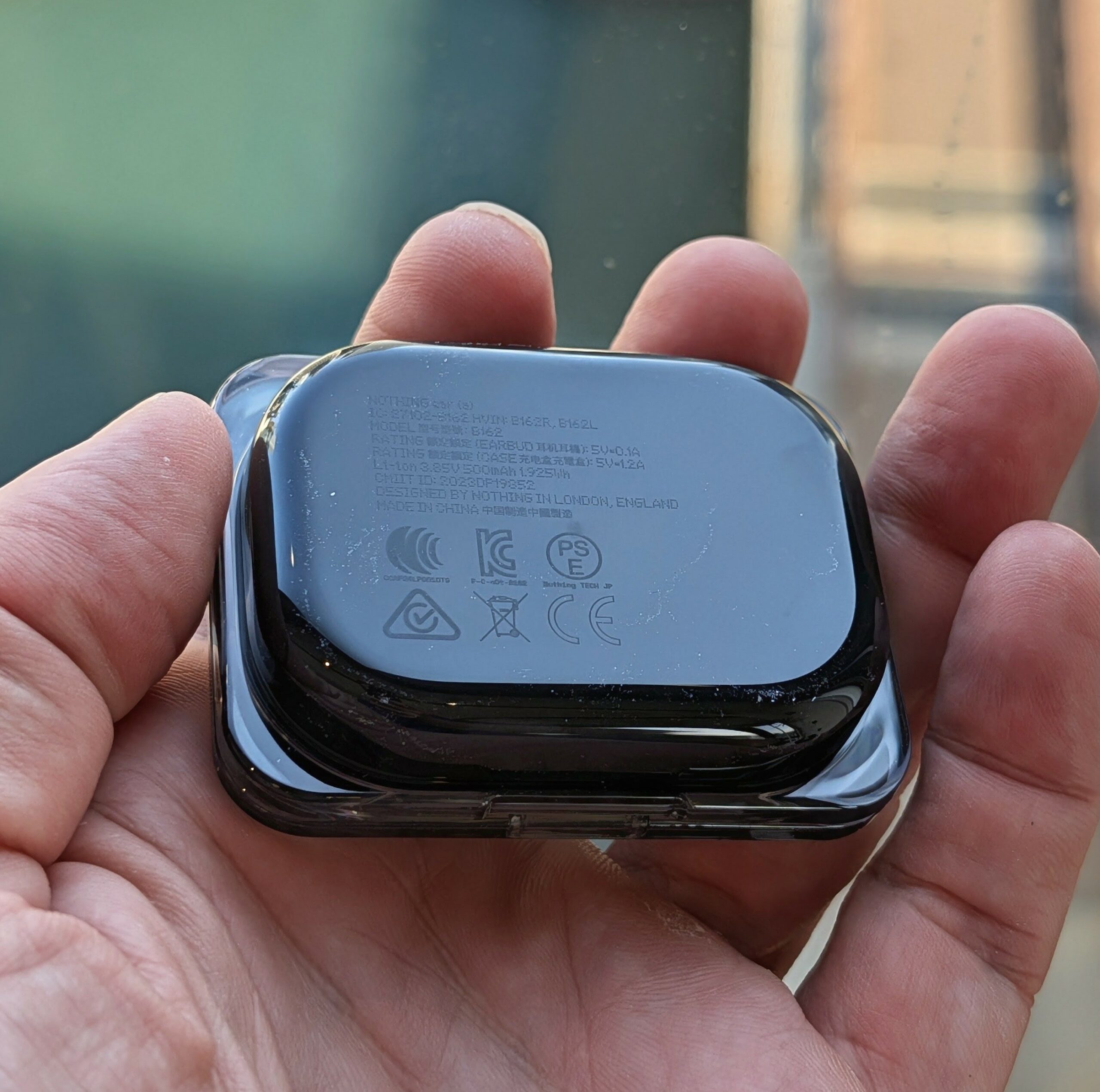 Bottom of Nothing Ear (a) charging case showing model number B162, regulatory markings, and "Designed by Nothing in London, England
