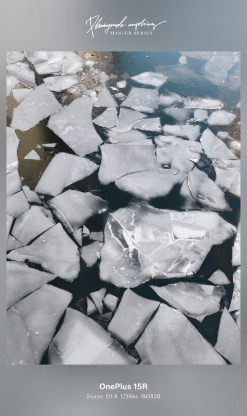 Sample photo taken with the OnePlus 15R main camera: broken ice sheets floating on dark water, shot at 24mm f/1.8 1/294s ISO320