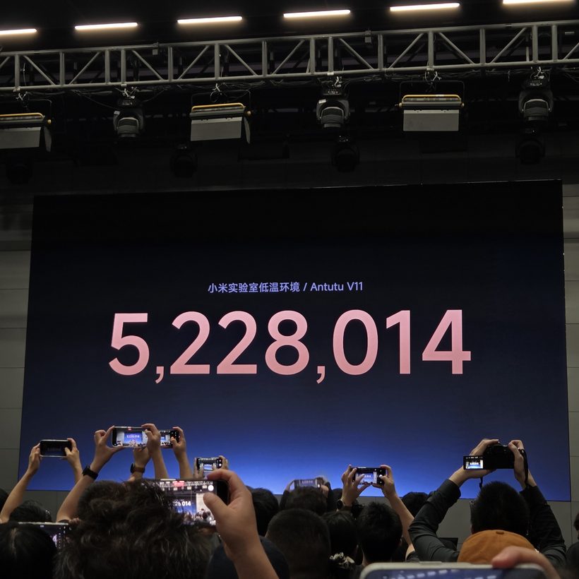 Onstage screen showing the O3's AnTuTu V11 score of 5,228,014, with attendees photographing it on their phones