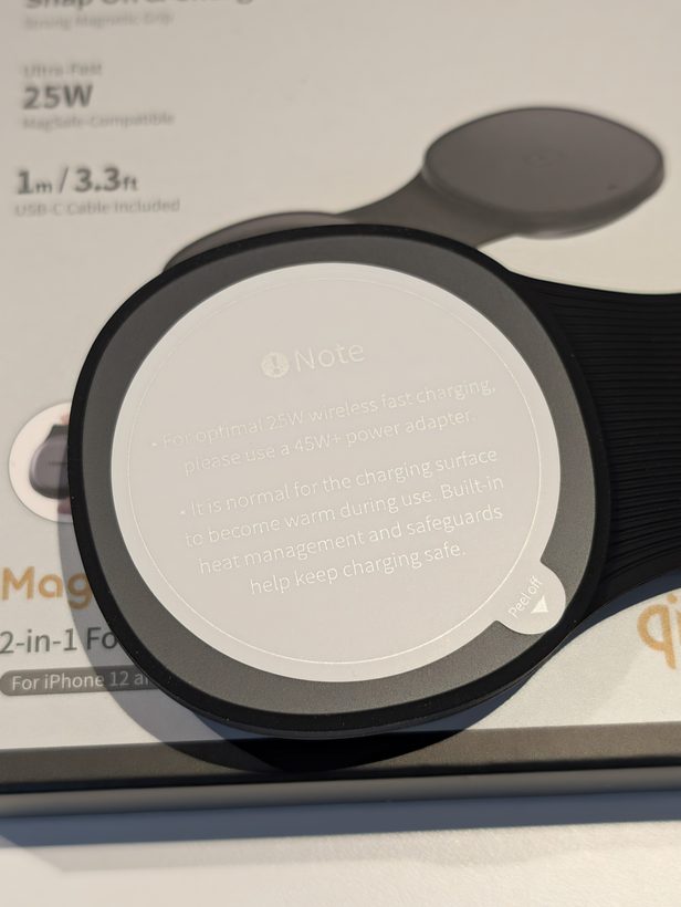 Peel-off note on the UGREEN foldable 2-in-1's charging pad, warning the surface will warm during use and to use a 45W+ adapter for full 25W speed
