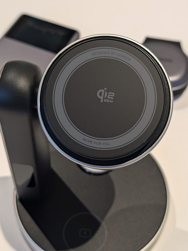 Close-up of UGREEN's 3-in-1 charging stand, showing the round Qi2 25W magnetic pad on its angled arm