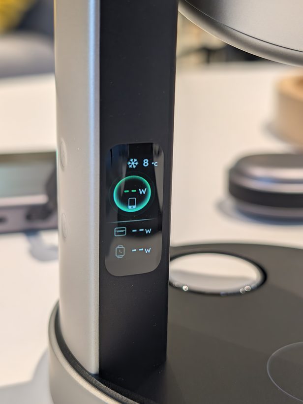 UGREEN 3-in-1 stand's display showing 8°C cooling temperature and separate wattage readouts for phone, cable, and watch charging